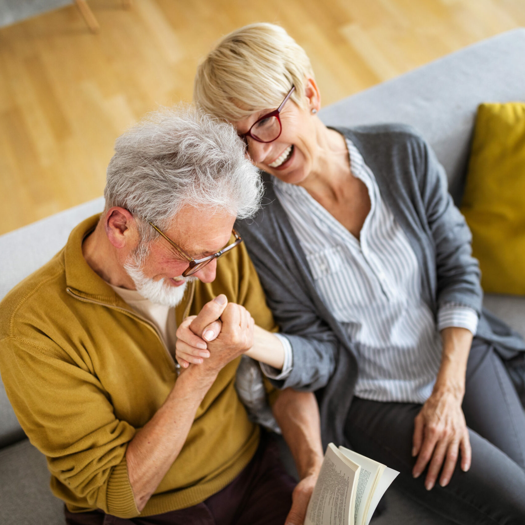 Cheerful senior couple enjoying life and spending time together at home